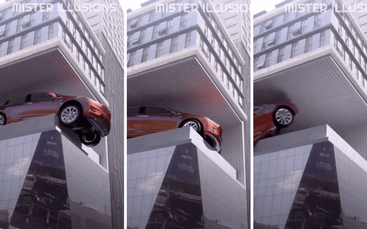 A billboard ad appears to be an optical illusion of a car driving off a building.