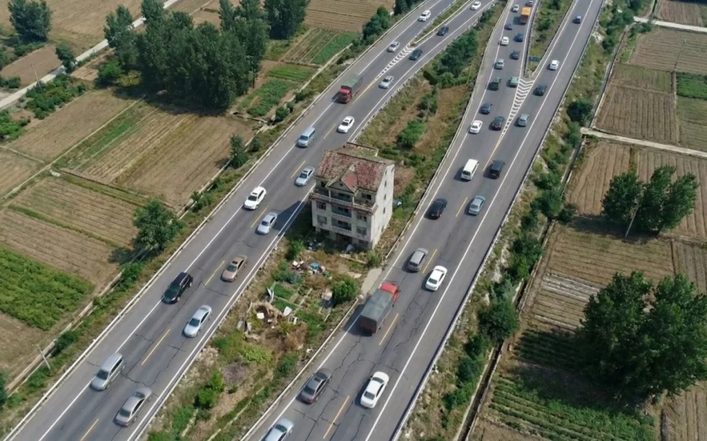 Chinese man who refused $200,000 to abandon his home now surrounded by highway reveals if he regrets it
