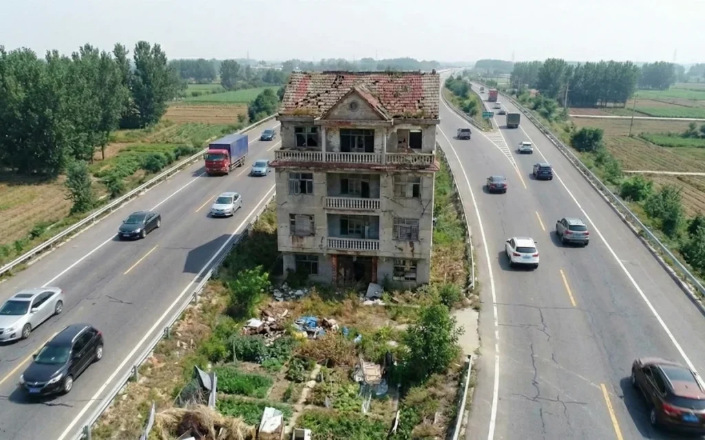 Chinese man who refused $200,000 to abandon his home now surrounded by highway reveals if he regrets it