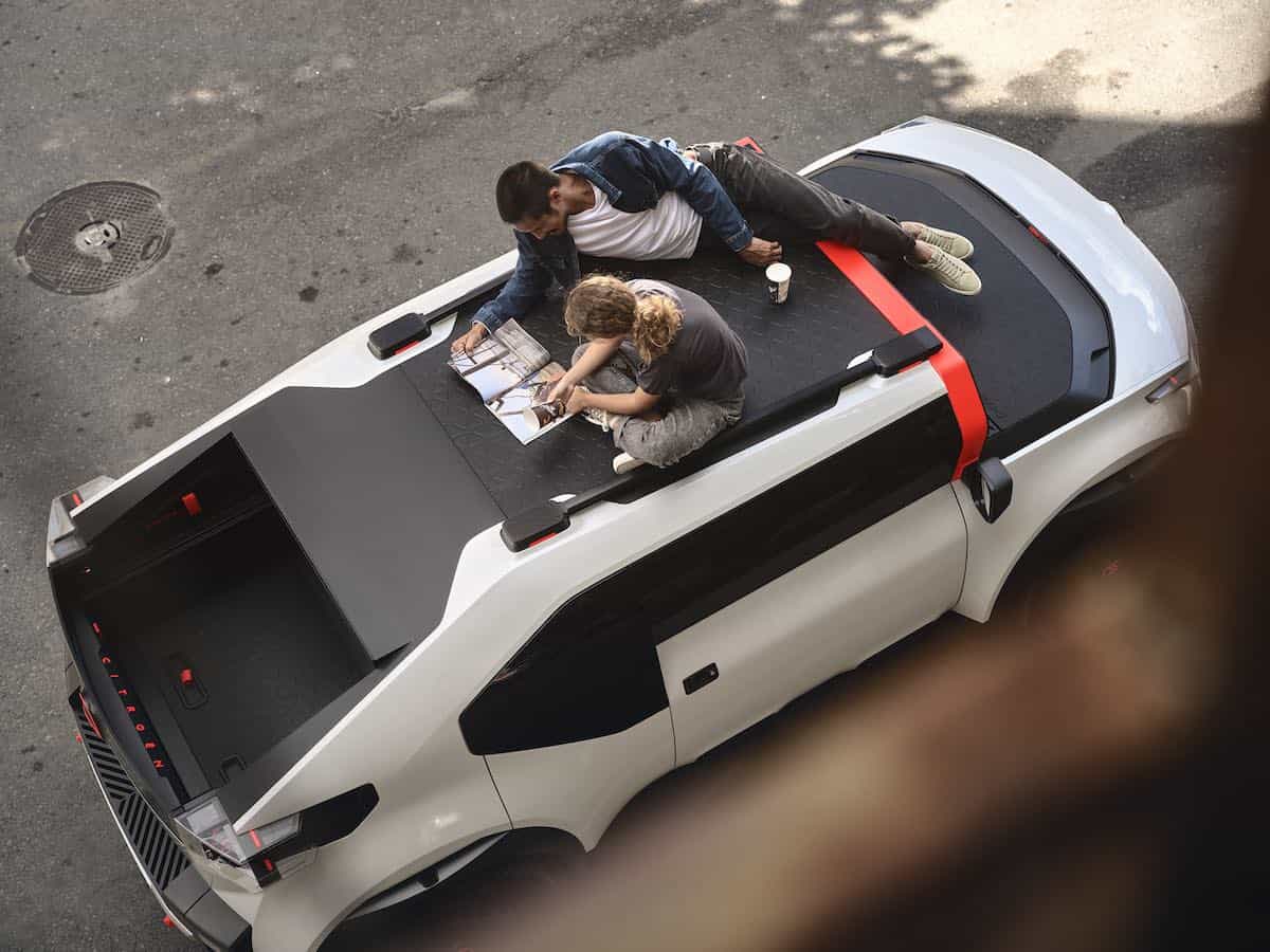 People sitting on roof of car