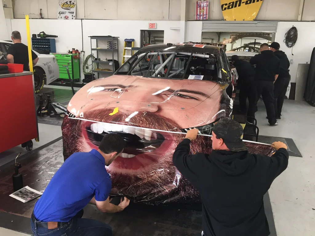 NASCAR driver Corey LaJoie became the first driver to cover the entire front of their car with their own face in a very surreal sponsorship deal