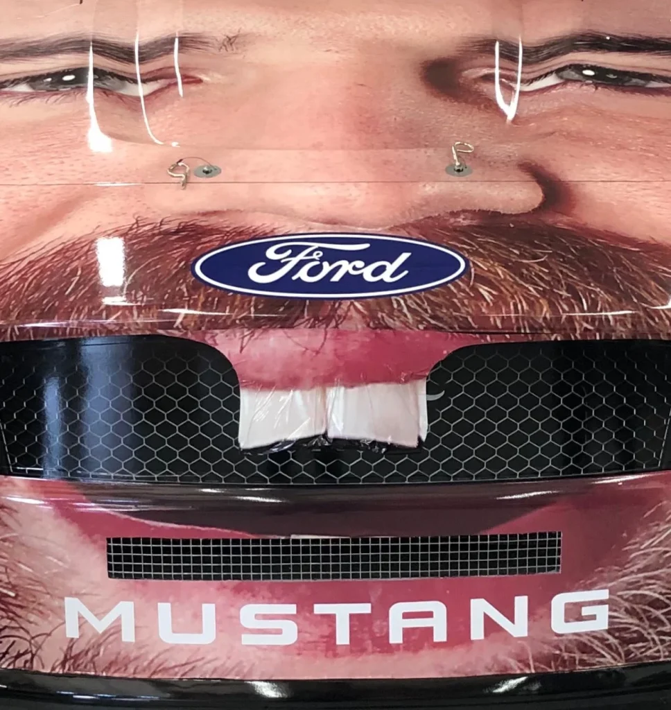 NASCAR driver Corey LaJoie became the first driver to cover the entire front of their car with their own face in a very surreal sponsorship deal