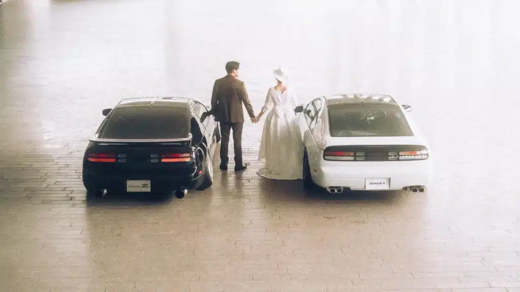 Couple pose with their Nissan cars