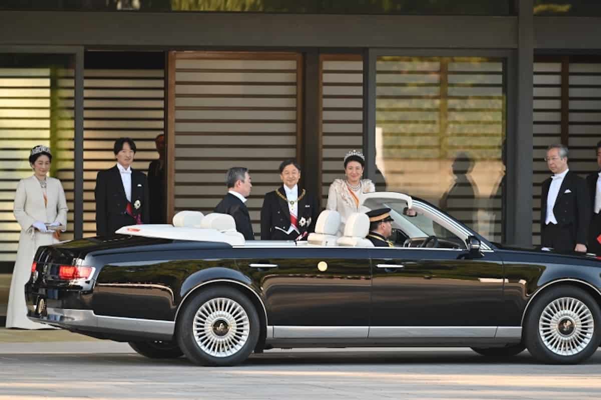 Emperor Naruhito preparing to get into a special Toyota Century convertible.