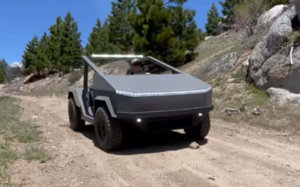 The newly built car drives on a dirt track.