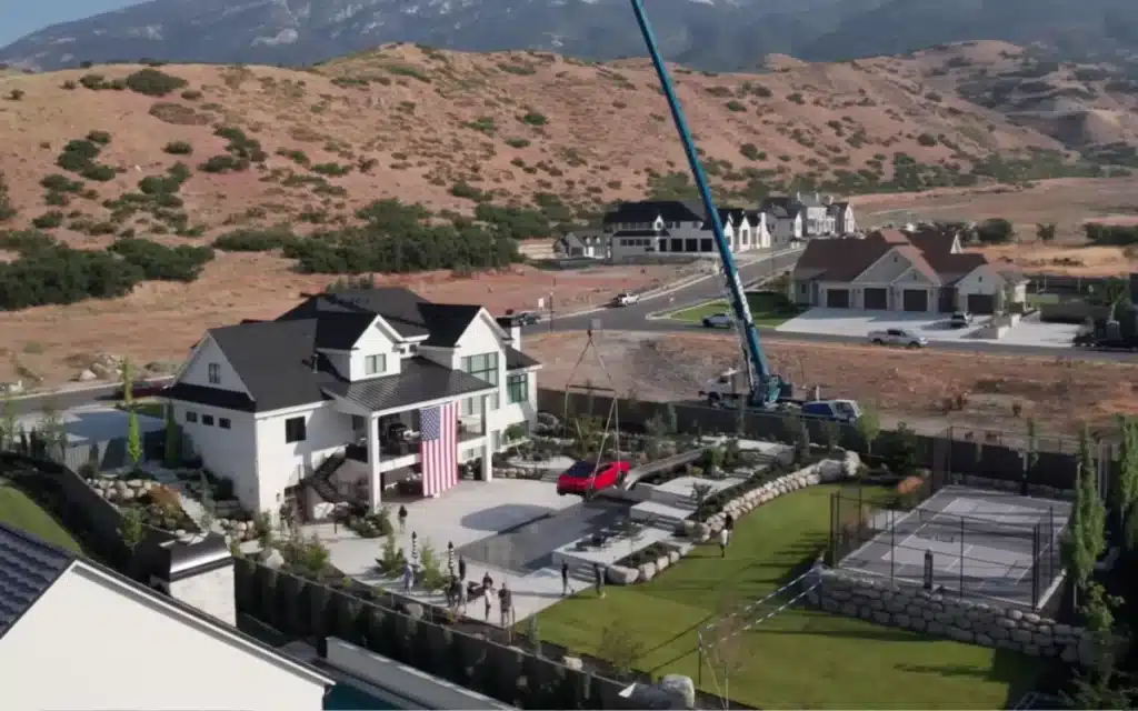 Tesla Cybertruck Craned onto swimming pool cover in US Mansion