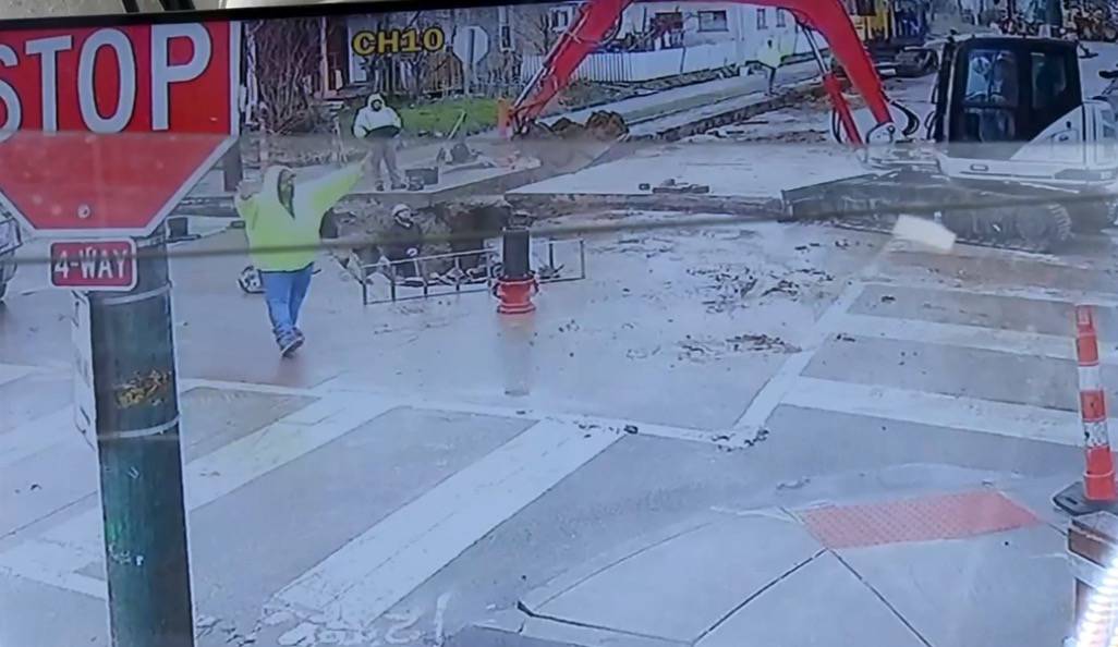 Construction site workers wave frantically