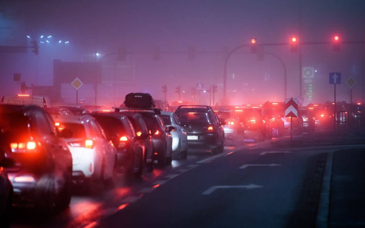 Cars in Poland queued up in traffic surrounded in smog.