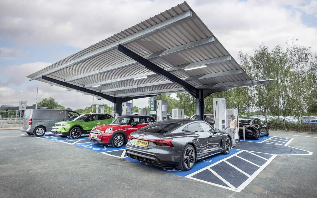 Electric vehicles plugged in at an EV charging station