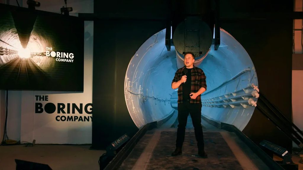 Elon Musk in front of the entrance of the tunnel