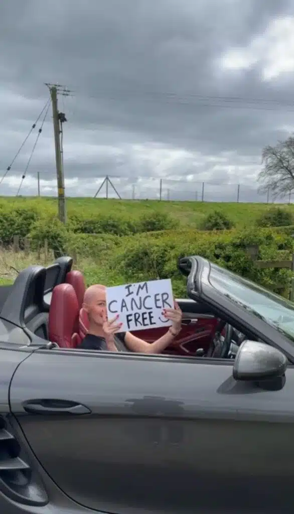 Woman celebrates beating cancer by driving into the sunset in her Porsche sports car