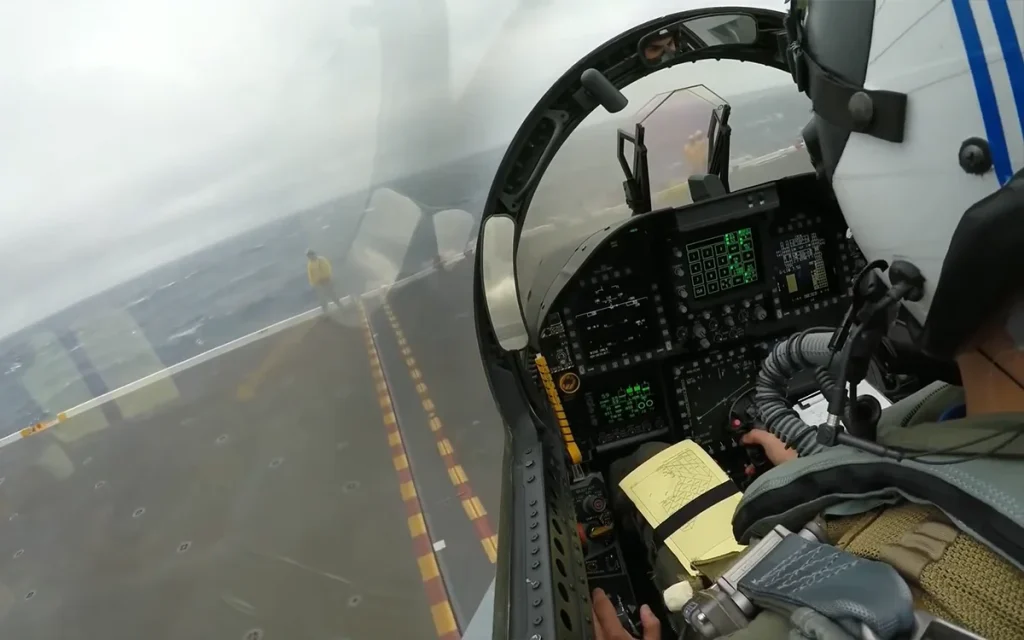 This cockpit view of an F-18 landing on a postage stamp in the middle of the ocean shows just how incredible these pilots are at flying fighter jets