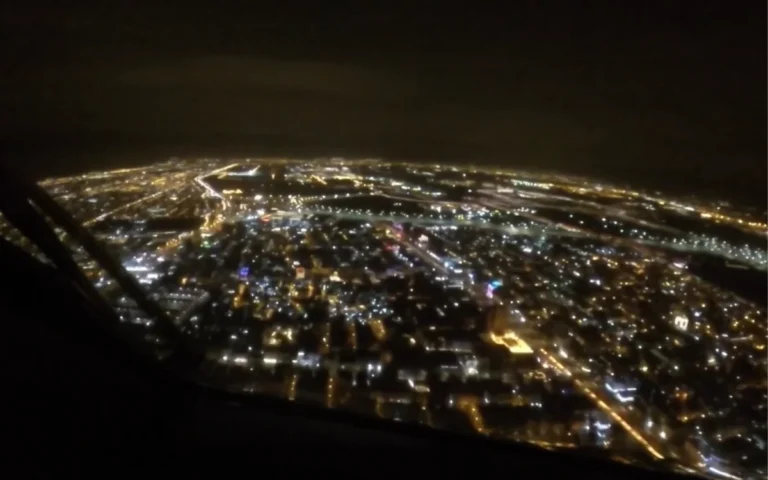 Pilot captures surreal view as city lights guide a night landing