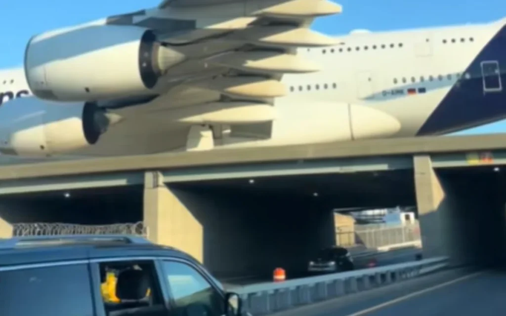 At JFK airport, cars drive under the tarmac while jets taxi overhead