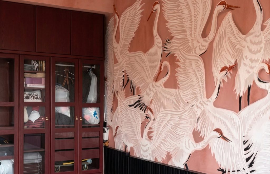 One homeowner completed a stunning garage makeover by using an IKEA closet and wallpaper to transform her boring parking space into a luxury room