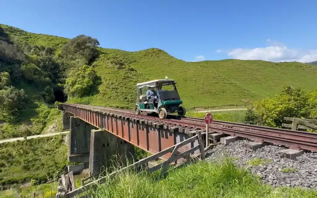 Canadian man's Golf Cart Train trip through New Zealand finds cool abandoned car