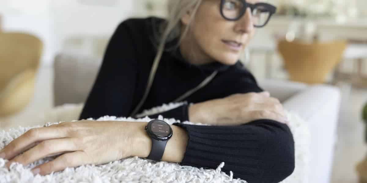 A woman with glasses wearing the Google Pixel Watch.