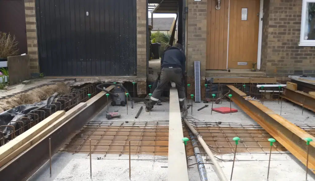 This secret underground garage features a hidden driveway, DIY garage design, and advanced concrete construction under a suburban home