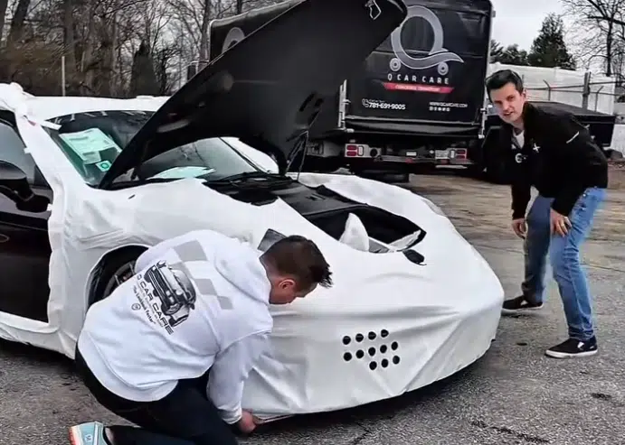 The Porsche Spyder RS arrives wrapped in Porsche protection as part of a supercar delivery process to avoid scratches, dust, and damage in transit