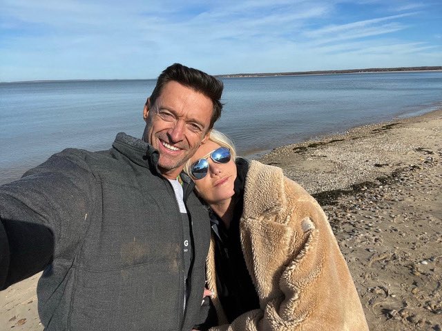 Hugh Jackman with his wife, Deborra-Lee Furness, on a beach.