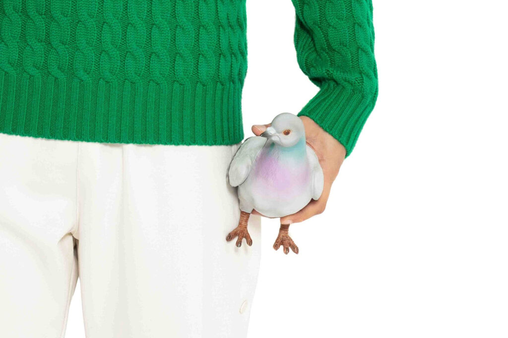JW Anderson's pigeon-shaped clutch bag, held in hand
