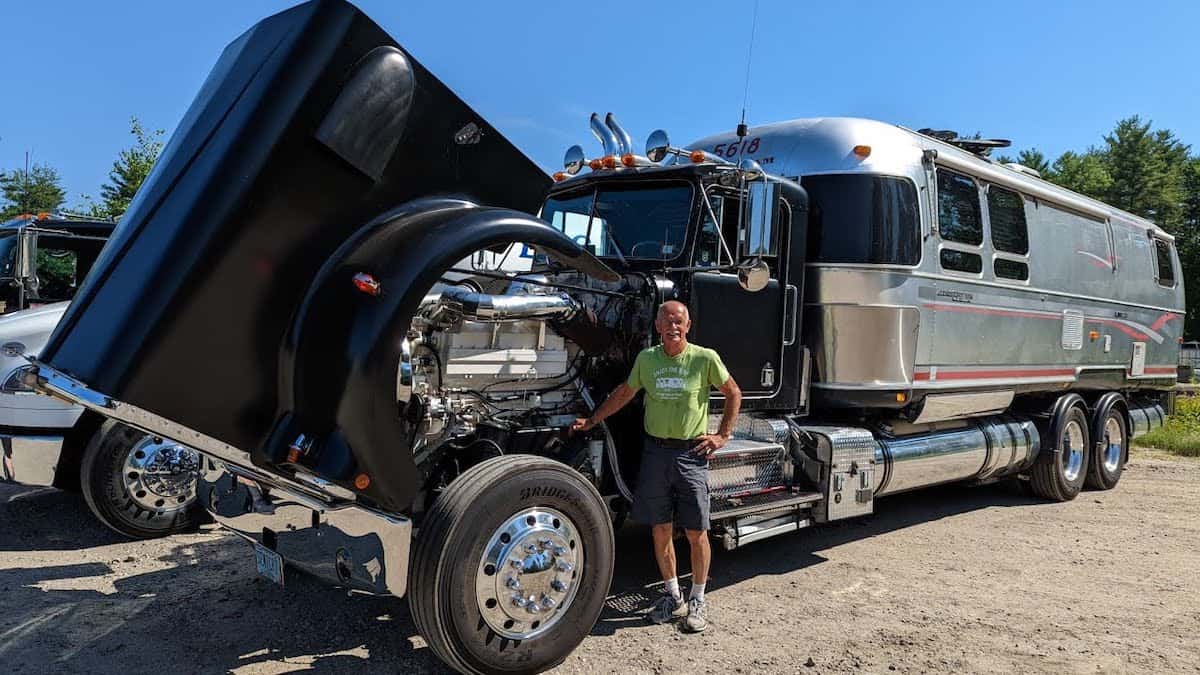 Retired trucker Charlie with his Kenworth truck that's fitted with an Airstream camper trailer