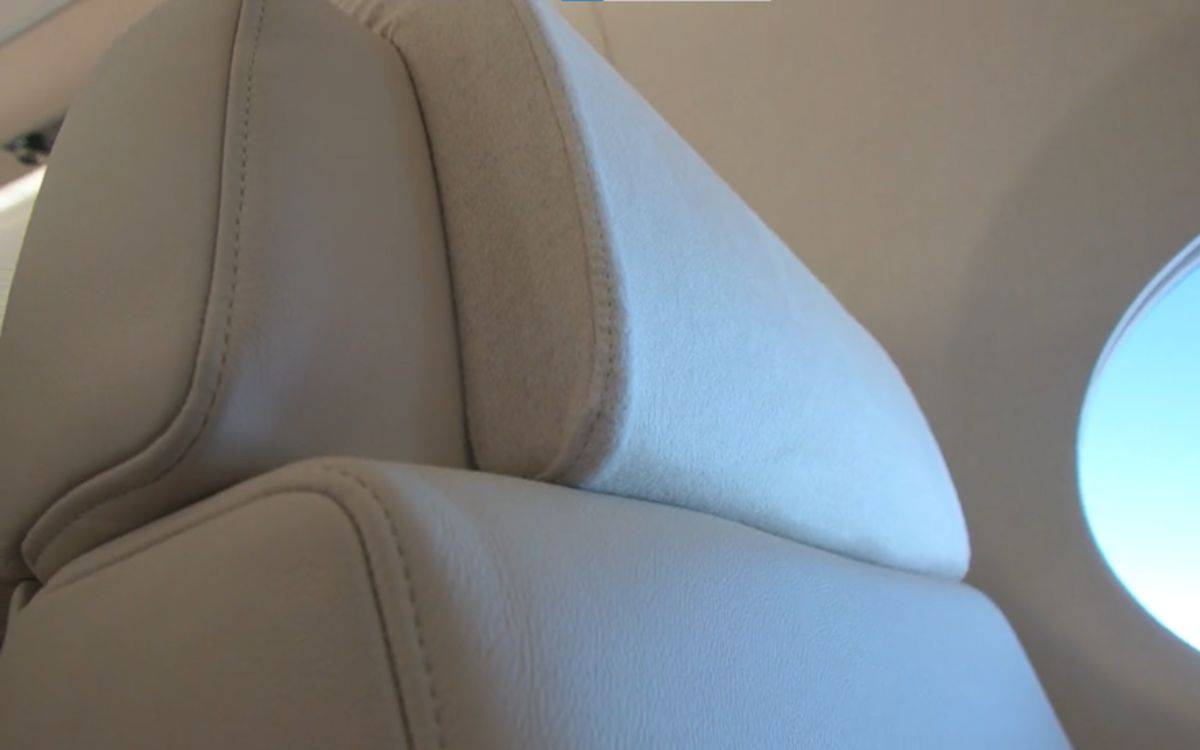 The cashmere on the headrest of a plane seat.
