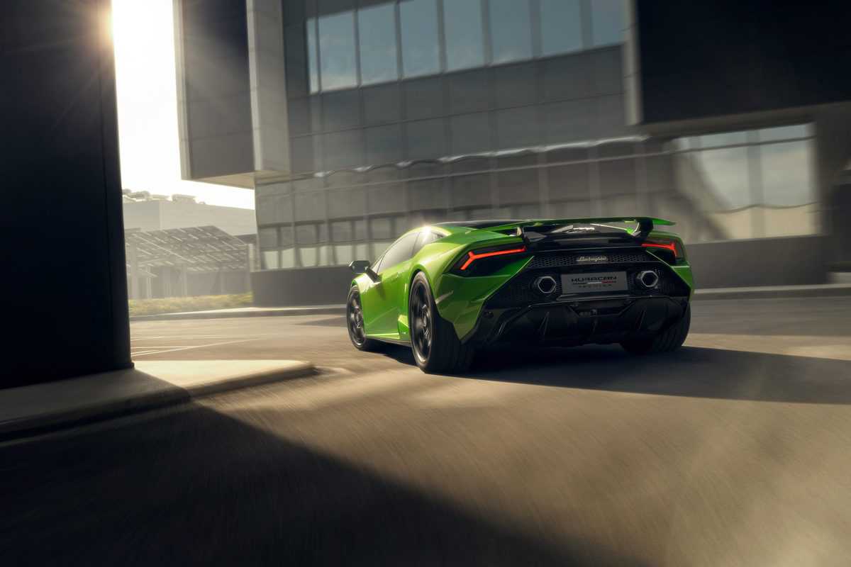 A rear angle of a green Lamborghini Huracán Tecnica as it turns a corner