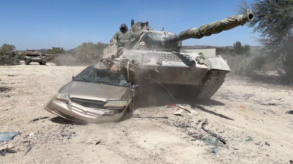 Leopard tank crushing a car