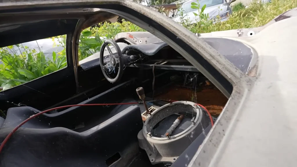 Emelia Hartford finds abandoned Lola T70 kit car hidden in overgrowth and missing major components but still wants to buy it