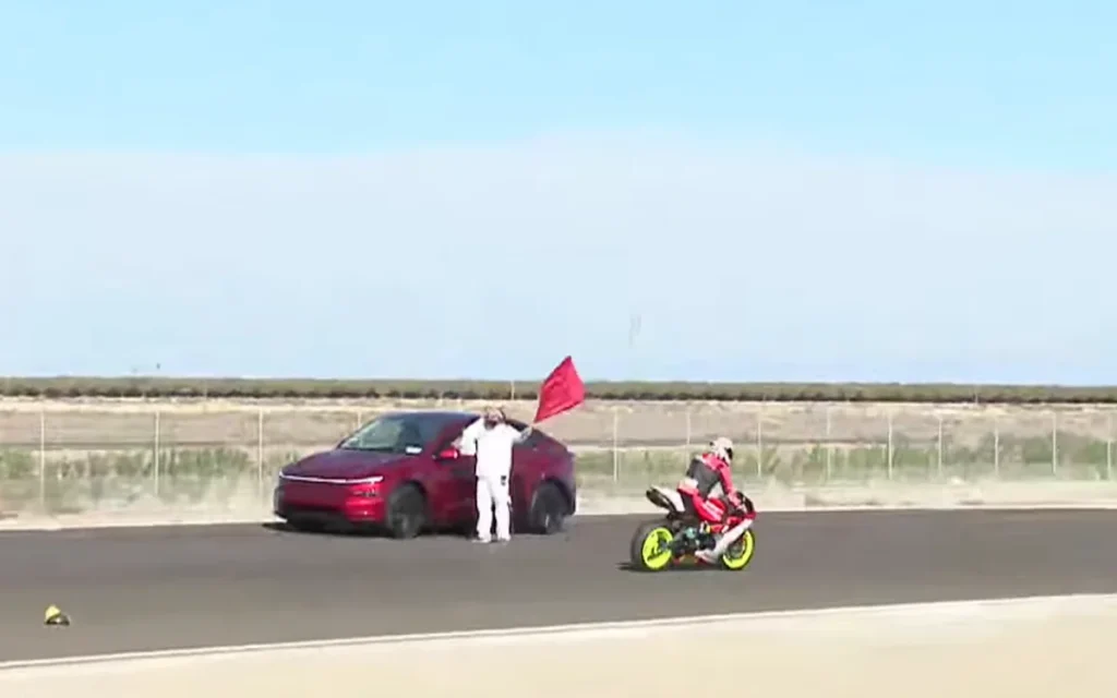 One Tesla driver left a motorbike racing commentator stunned after it halted an official race by driving the wrong way onto the hot track