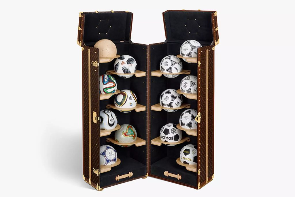 Louis Vuitton World Cup trunk with the balls on display.