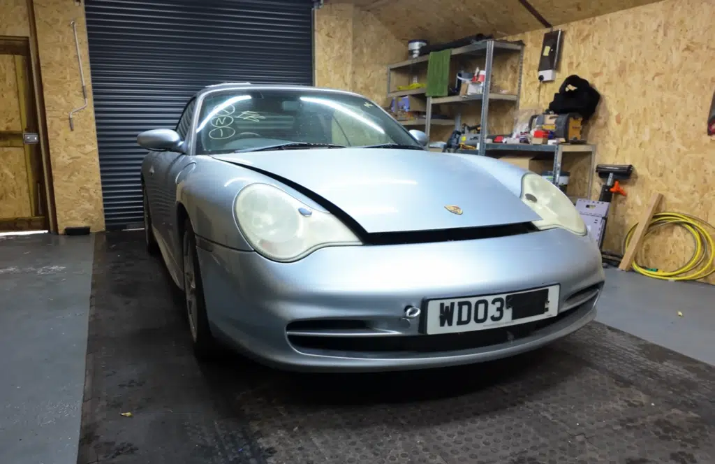 A fire-damaged Porsche 911 from a Copart auction was turned into a successful car restoration project and flipped for profit after careful repairs