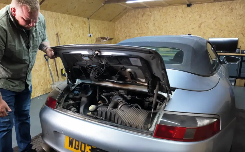 A fire-damaged Porsche 911 from a Copart auction was turned into a successful car restoration project and flipped for profit after careful repairs