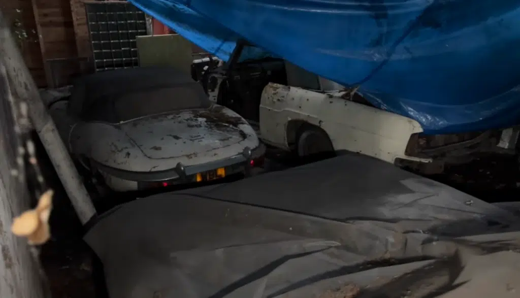 A rare Jaguar E-Type was found in an abandoned farm alongside a classic Cadillac and a Suzuki Jimny, left untouched for decades
