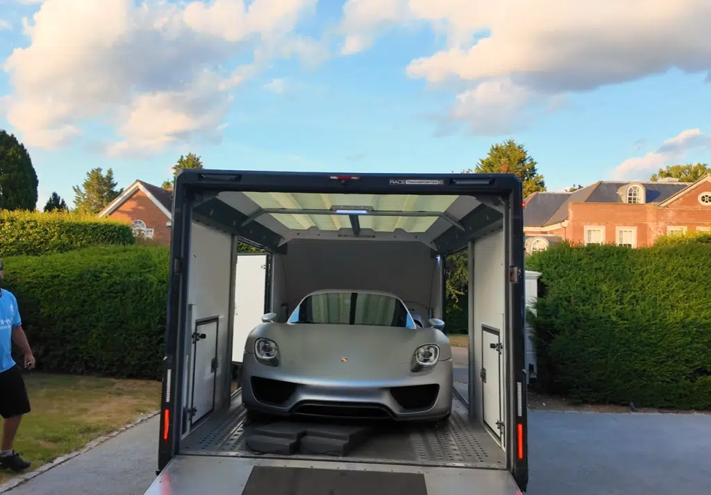A Porsche 918 hybrid hypercar is delivered in a surprise moment before joining a Goodwood convoy for its first proper drive on public roads