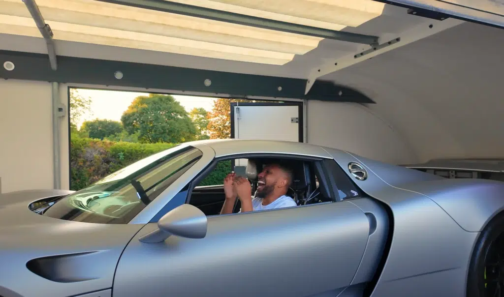 A Porsche 918 hybrid hypercar is delivered in a surprise moment before joining a Goodwood convoy for its first proper drive on public roads