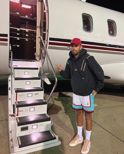 Nick Kyrgios in front of private plane