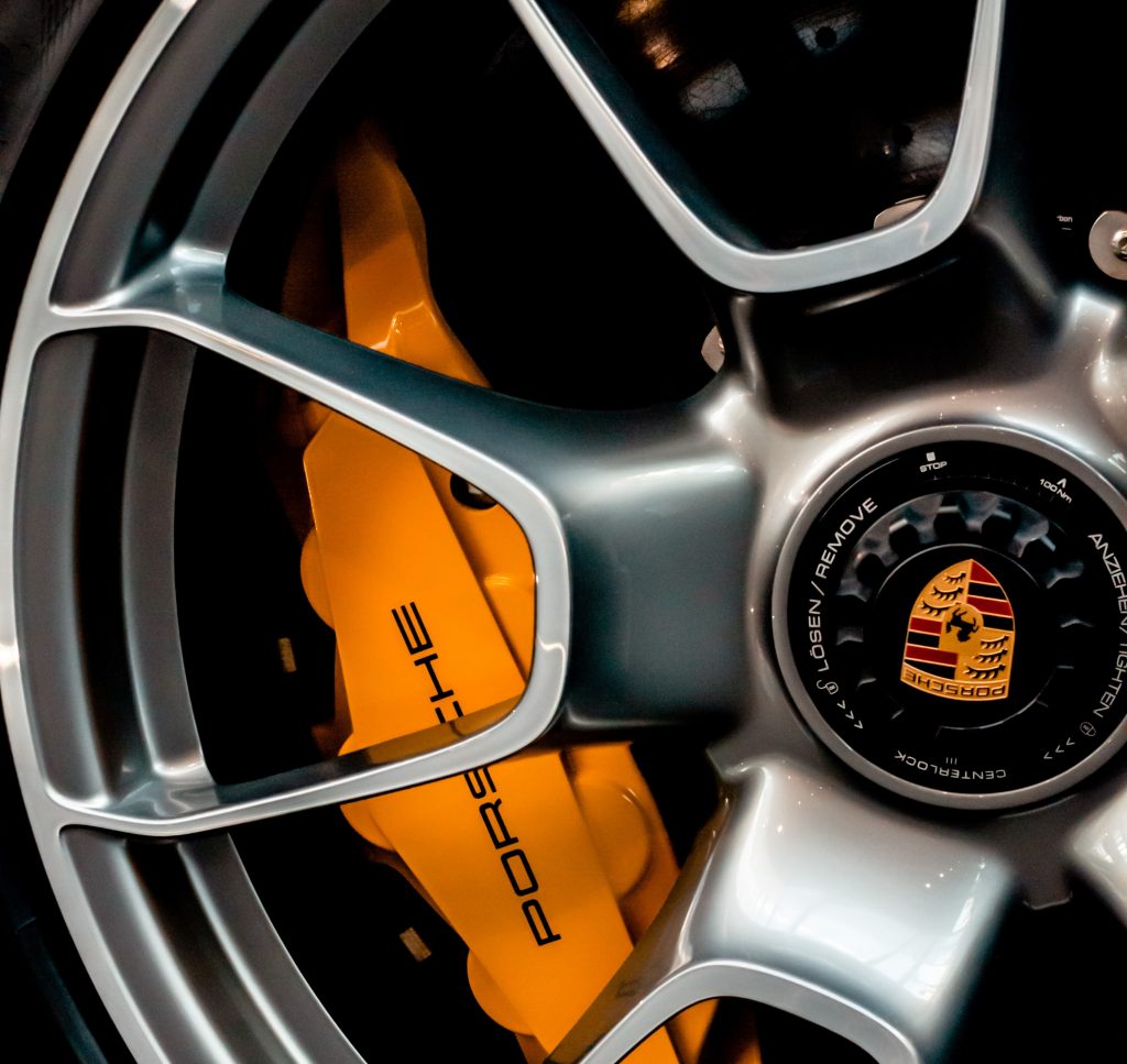 A close up of a Porsche wheel rim and brake caliper.