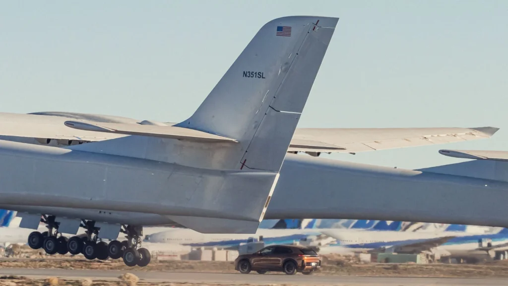 Most powerful production Porsche sets a new record after driving under world's biggest aircraft as it takes off and lands