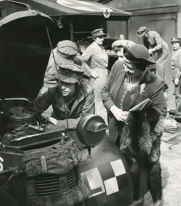 Queen Elizabeth II working on a car during WWII