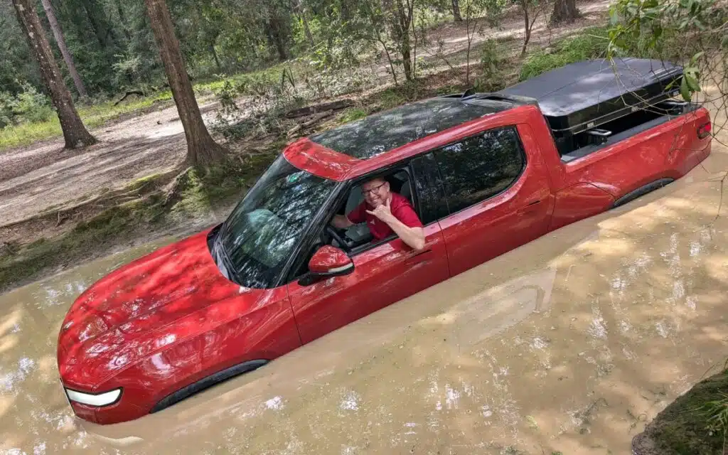 Rivian-R1T-serves-as-a-boat-on-a-heavily-flooded-road-and-its-warranty-remains-valid