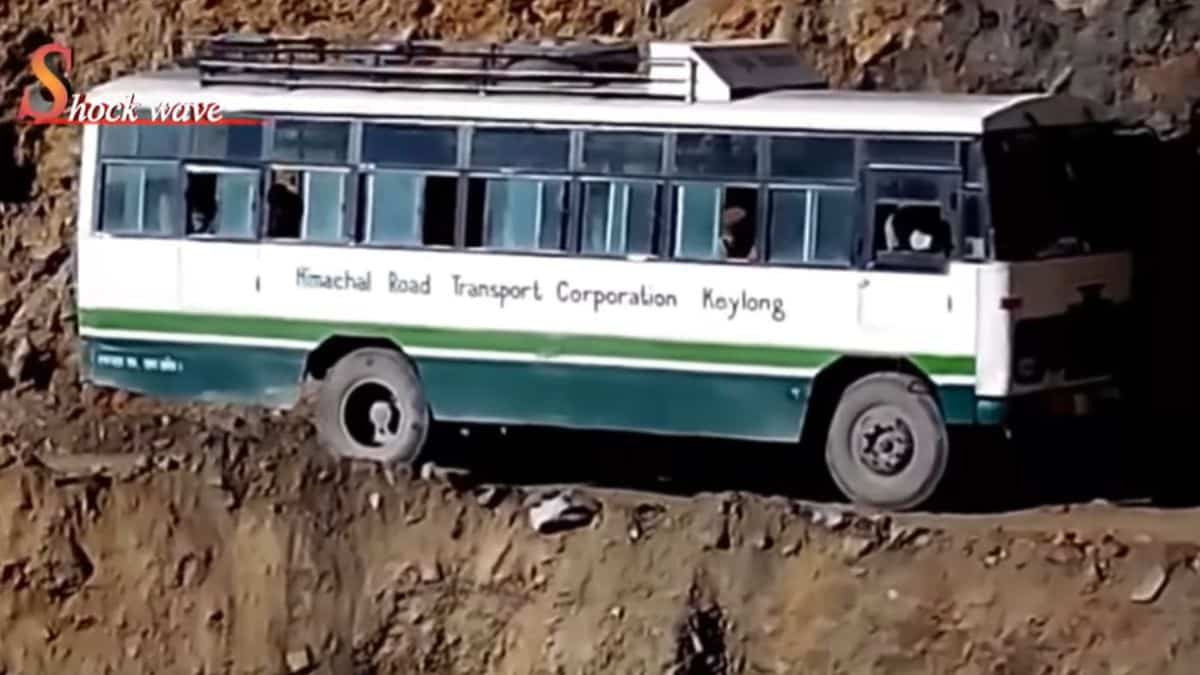 A bus navigates a narrow stretch of Rohtang Pass, India.