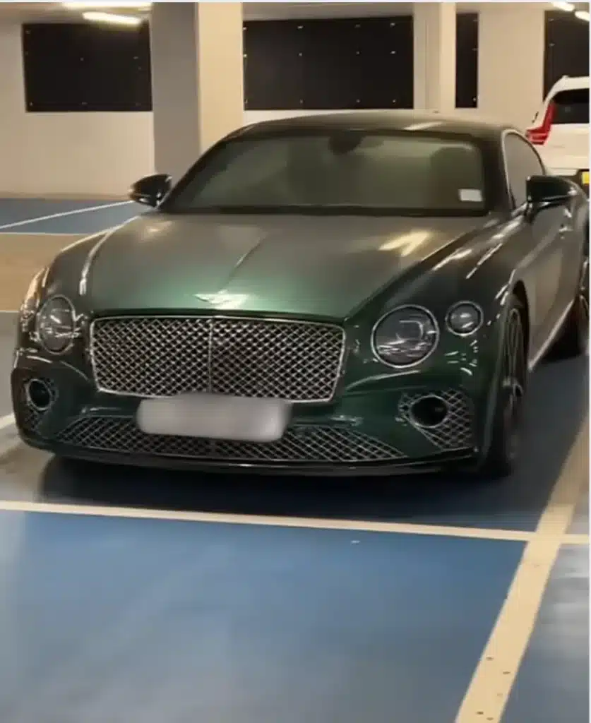 Man in London parking lot spot surrounded by supercars