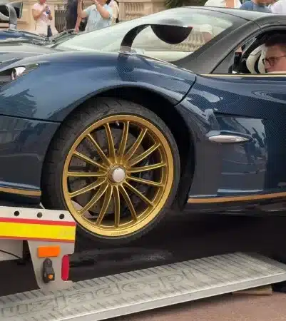 Pagani Huayra Roadster supercar being unloaded badly from a trailer
