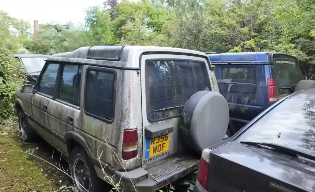 Explorers uncovered a Ferrari GT at a UK abandoned estate filled with American muscle cars, revealing a decaying collection of classic cars