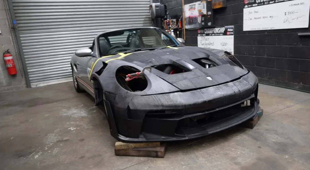 A builder is using 3D printing to recreate a Porsche GT3 RS from a Porsche Boxster base, relying on consumer-grade $500 printers