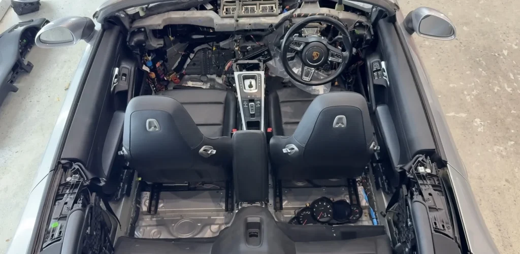 A Porsche 911 with lightning damage from a salvage auction became a long repair saga with gearbox failures, high costs, and hidden electrical faults