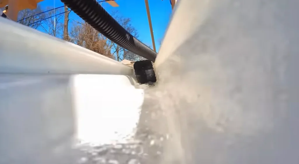 Someone built a 12-foot-tall Hot Wheels track that starts on a roof and uses water, lifts, and buckets to keep a tiny car moving through an entire backyard