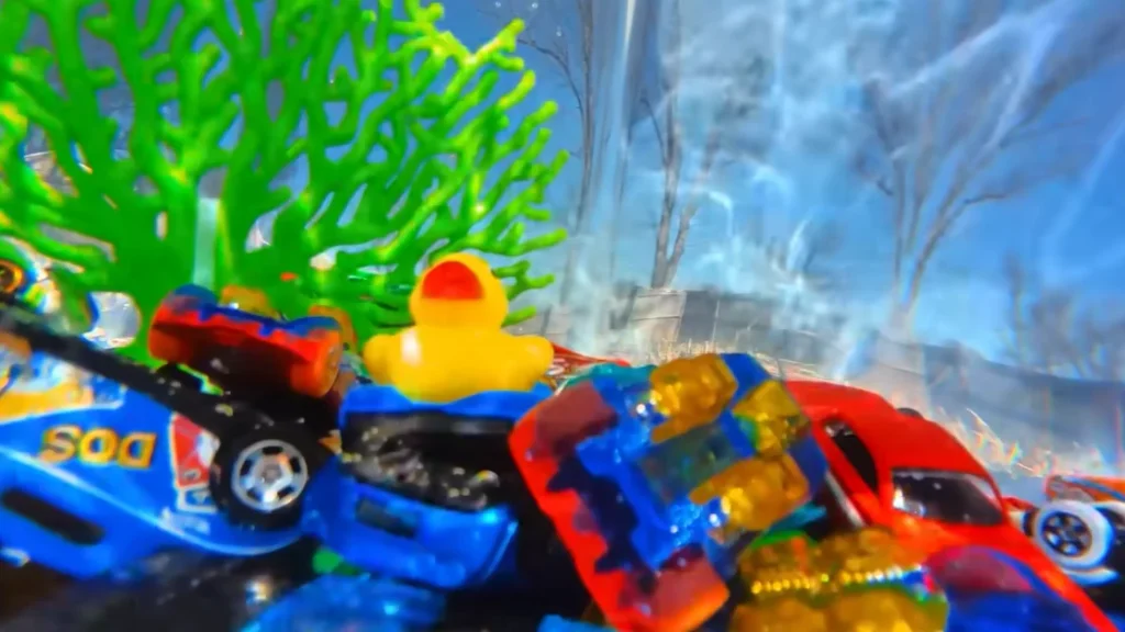 Someone built a 12-foot-tall Hot Wheels track that starts on a roof and uses water, lifts, and buckets to keep a tiny car moving through an entire backyard